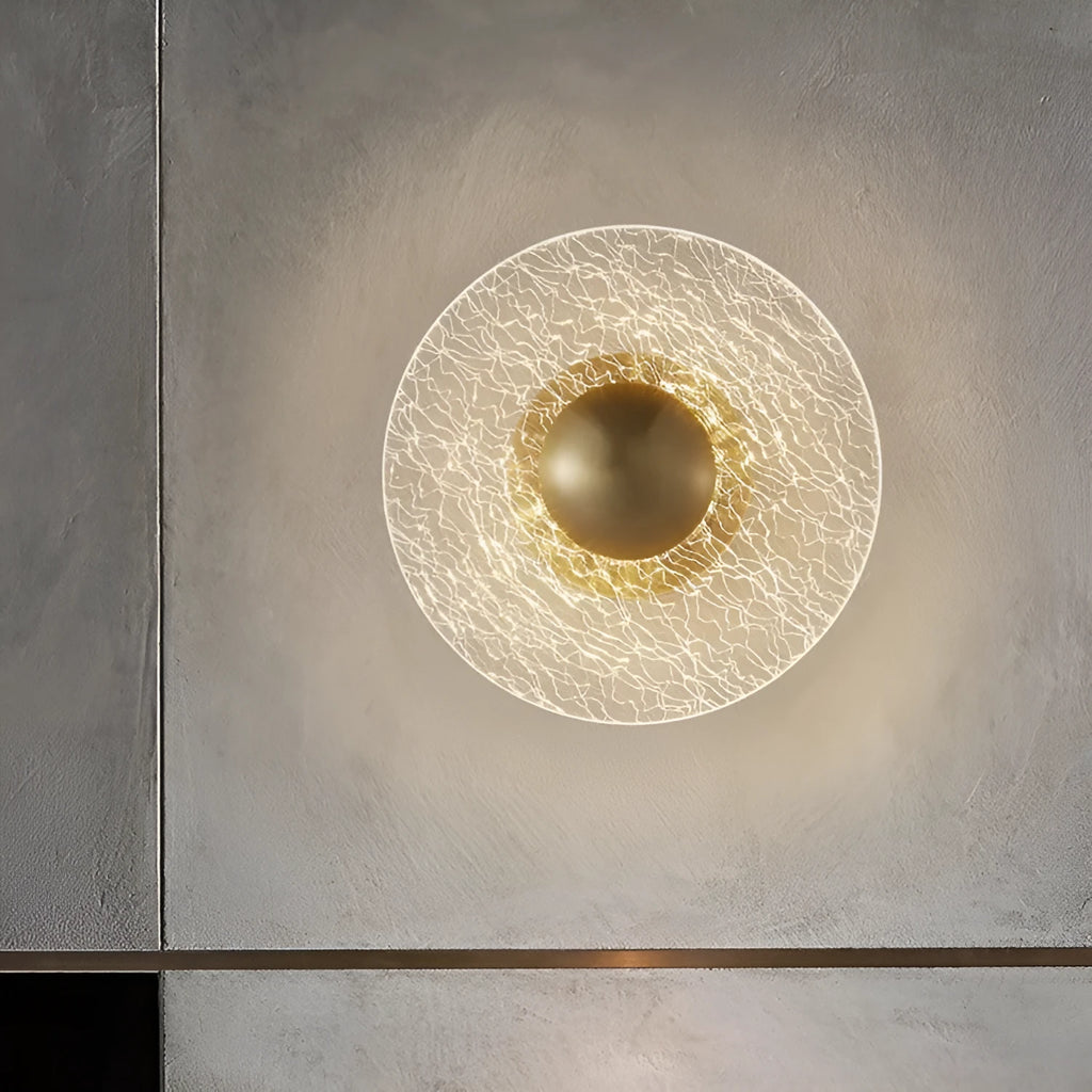 Designer wall lamp with wrought iron frame and acrylic leaf-style shade illuminating a room.