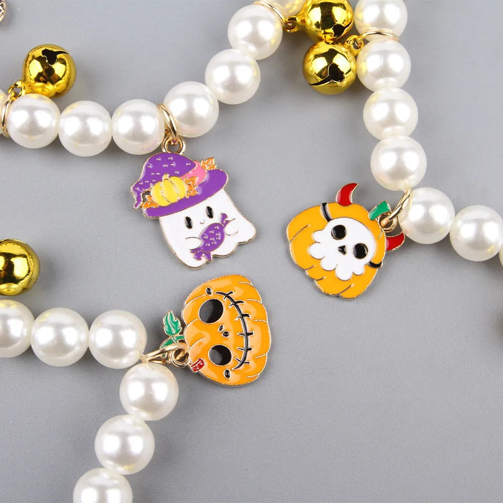Halloween cat collar with simulated pearl necklace and pumpkin designs including purple ghost, skull, and smiling patterns