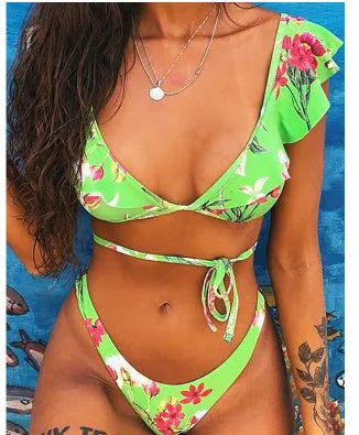 Yellow floral print split bikini swimsuit on a hanger, showing top and briefs.