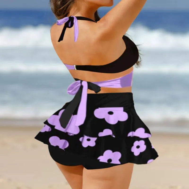 Women's purple high-waisted bikini swimsuit with skirt and lace-up back detail
