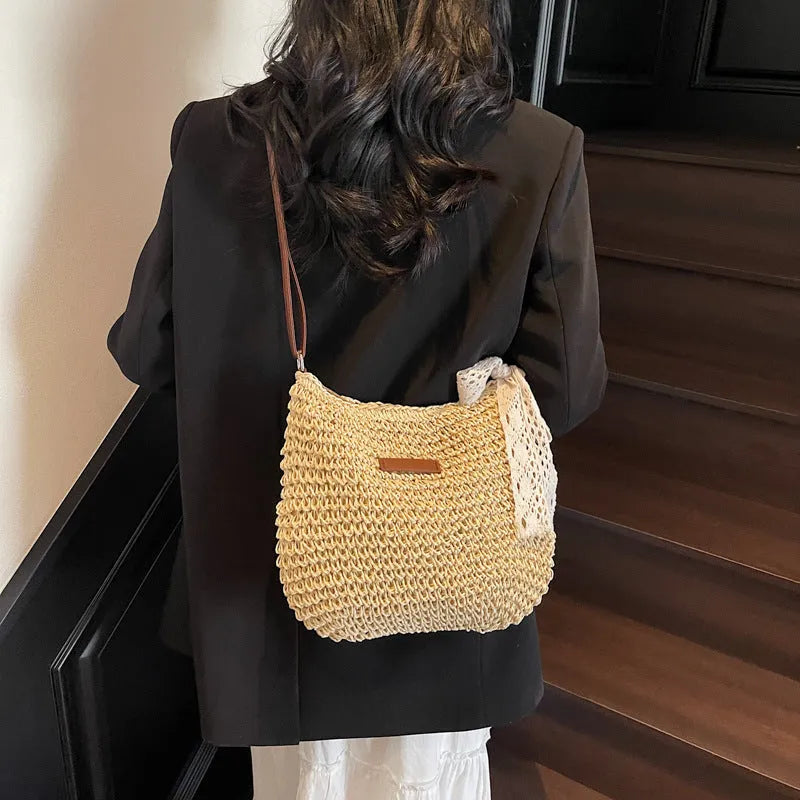 Women's woven straw messenger bag in khaki colour with shoulder strap