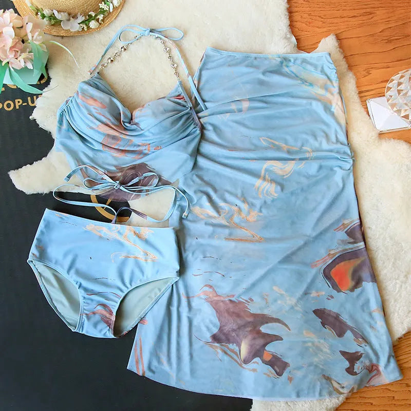 Women's floral print bikini set with triangle top, briefs, and skirt featuring steel wire support