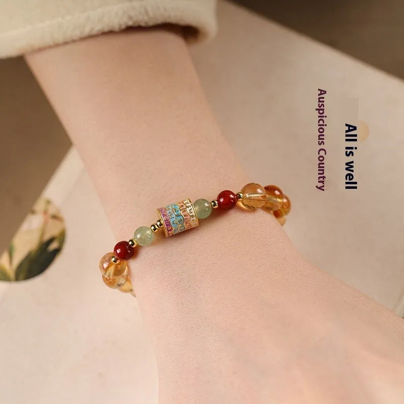 Yellow citrine prayer wheel bracelet with 8mm round beads and adjustable fastening