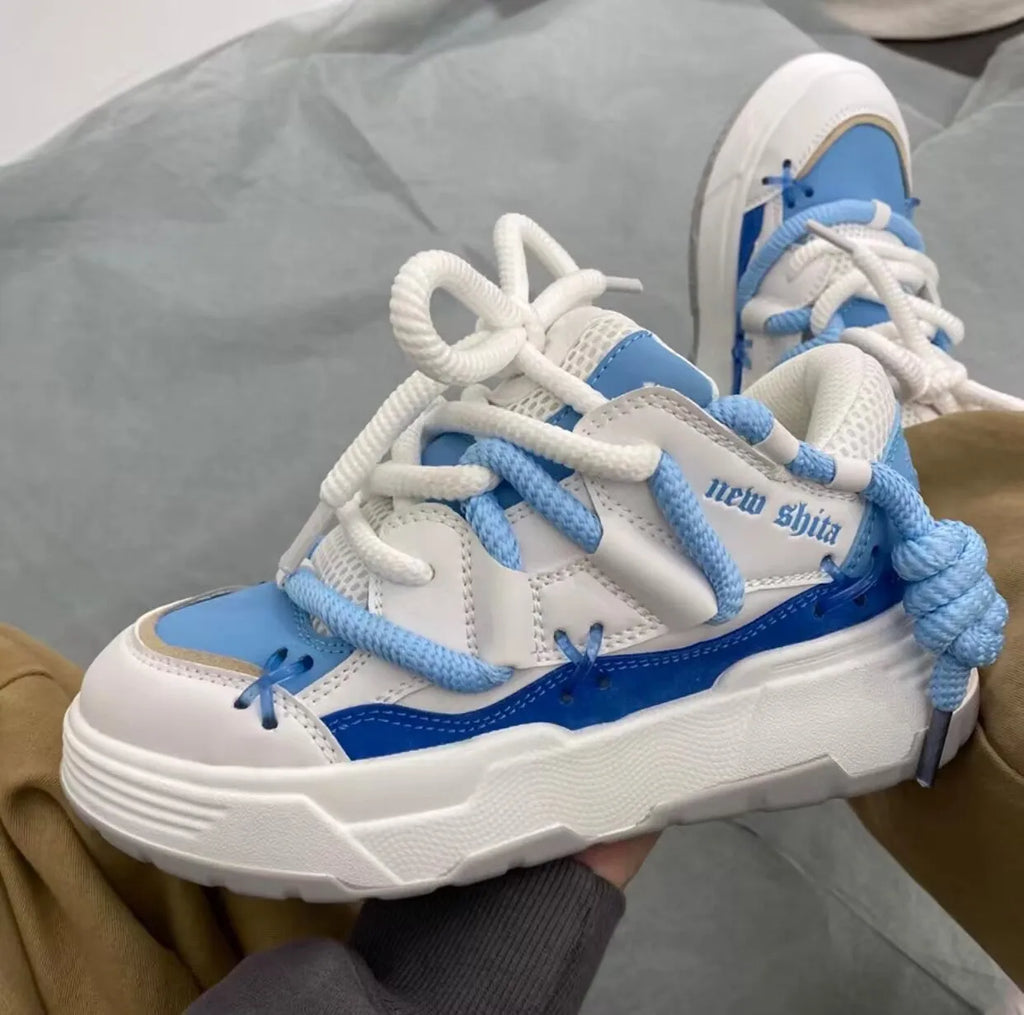 Women's grey clunky sneakers with thick rubber sole and round toe, shown with blue and black colour options.