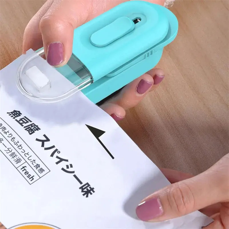 Handheld ABS bag sealer and resealer with cutter, battery powered, 100 x 38 x 35mm, in black, white or Lake Blue.