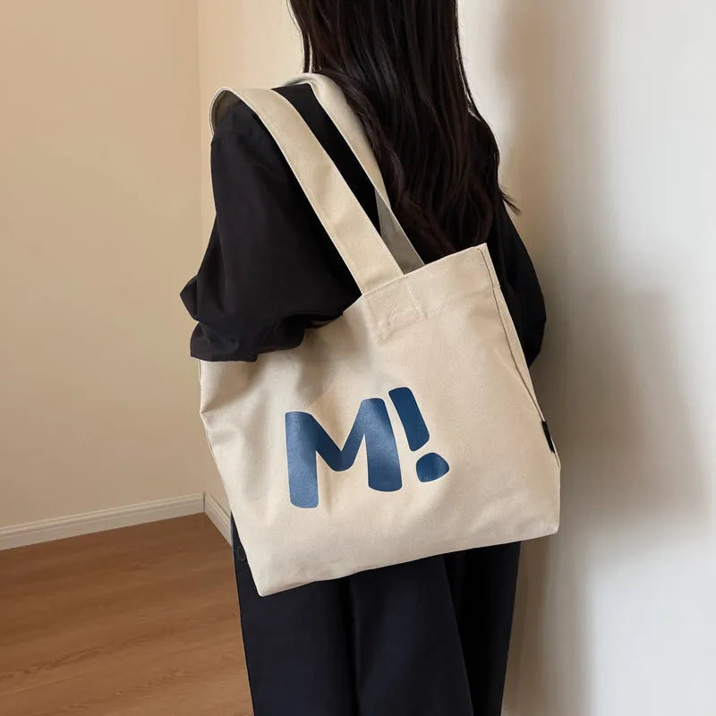 Letter print canvas shoulder bag in dark brown, large capacity tote with shoulder strap for women and girls.