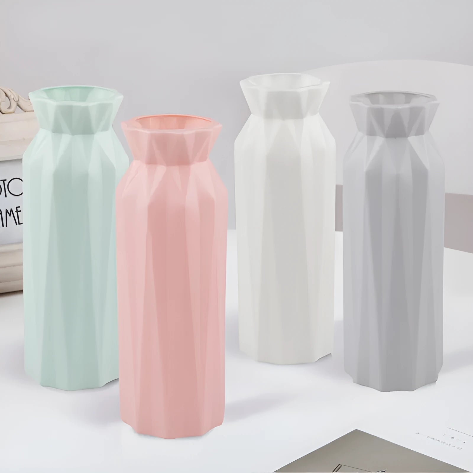 Simple green melamine plastic vase with a 7.2cm base diameter on a wooden table.