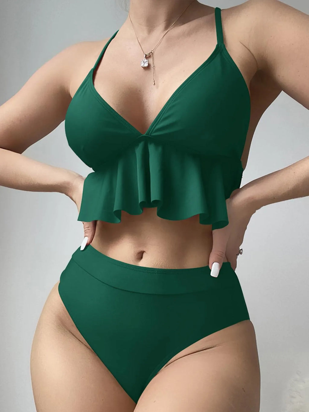 Women's solid colour split bikini swimsuit in polyester fabric on a mannequin