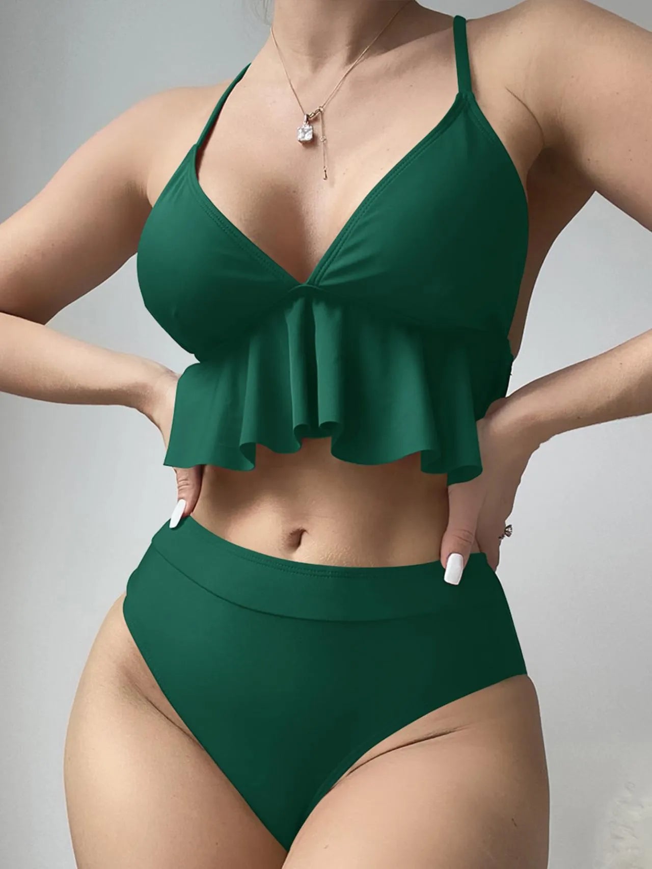 Women's solid colour split bikini swimsuit in polyester fabric on a mannequin