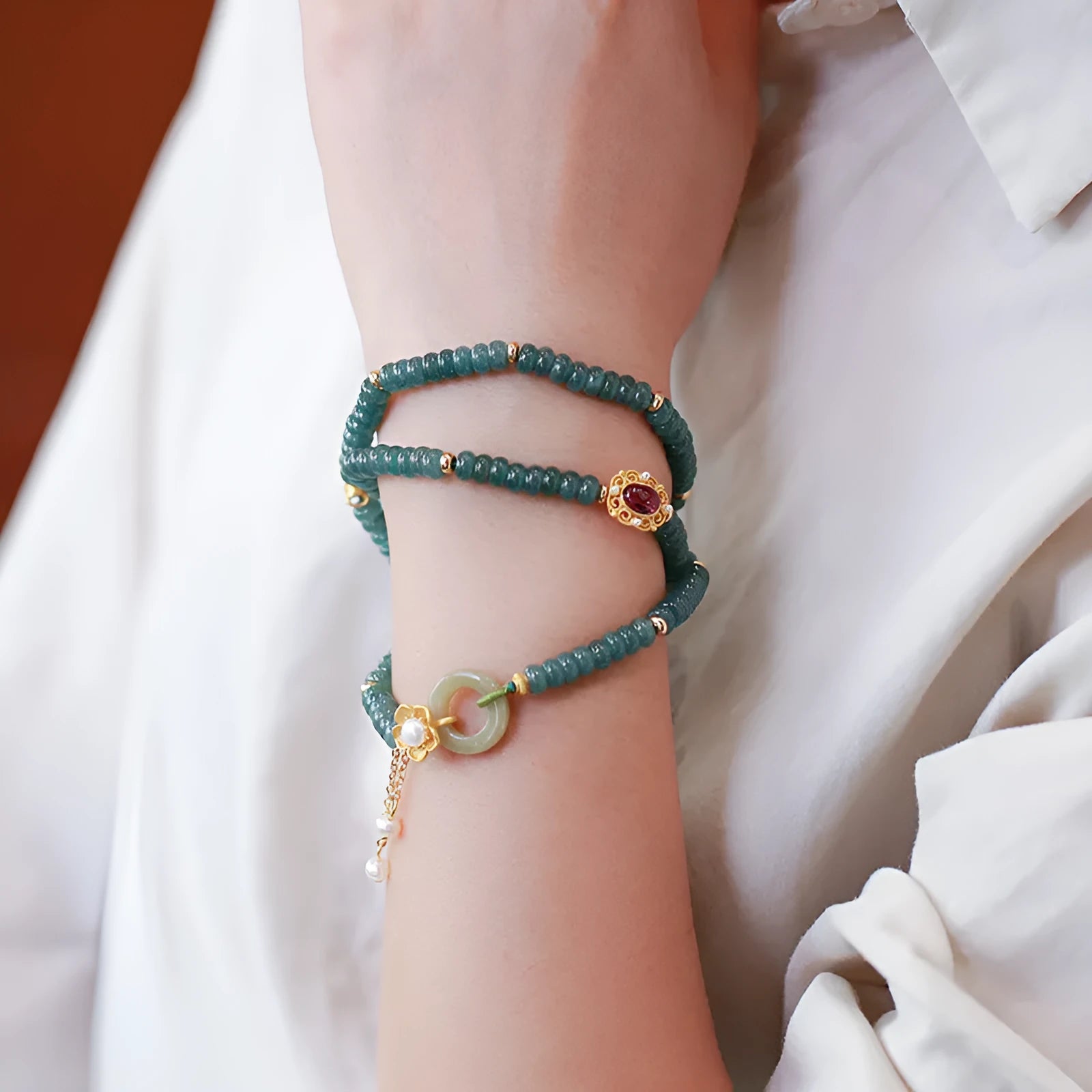 Blue water jade abacus bead and tourmaline bracelet on three sterling silver rings for women.