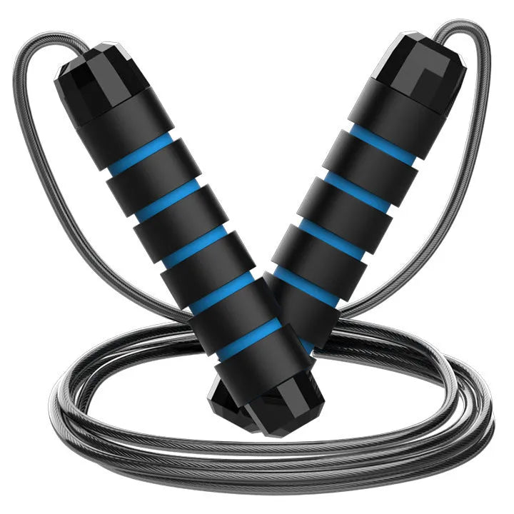 Steel wire jump rope with black PP handle on a dark background for fitness training