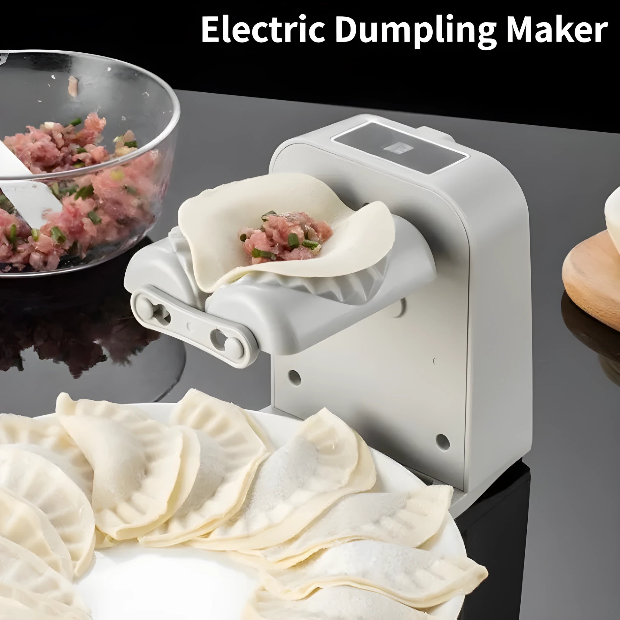White automatic electric dumpling maker machine with USB cable and accessories on a kitchen counter.