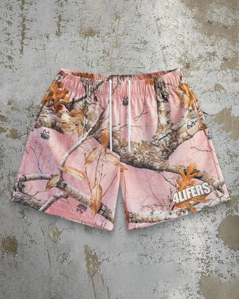 Man wearing loose-fitting quick-dry beach shorts with a digital print pattern in a summer setting.