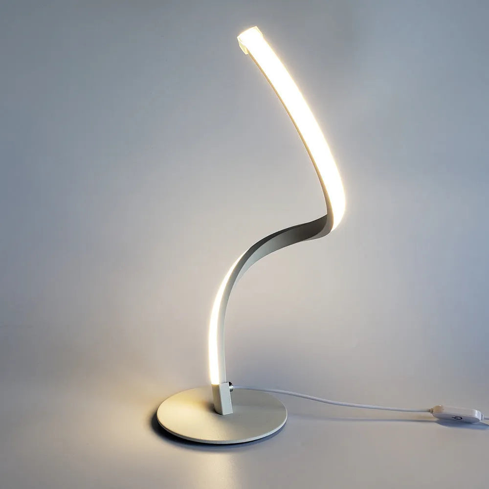 Advanced touch dimming desk lamp in white with white light mode on a bedside table
