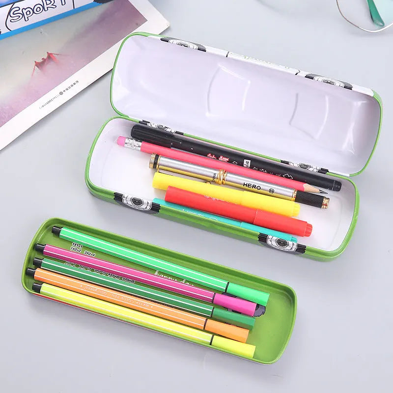 Metal tinplate stationery box with racing car trolley cartoon pattern, shown closed.