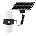 Black outdoor solar floodlight with motion sensor on wall bracket