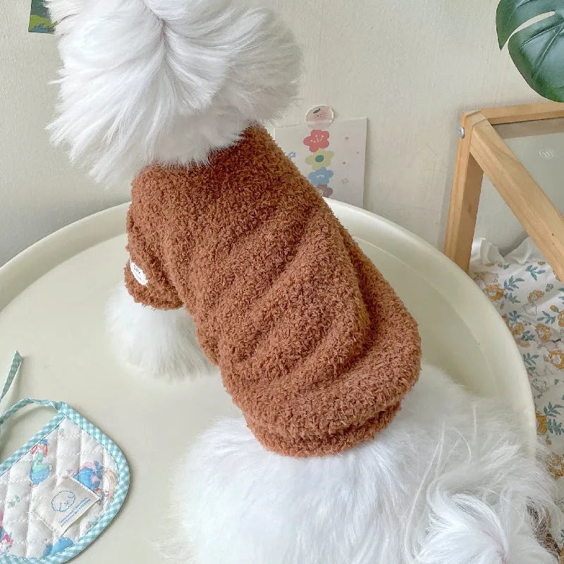 A small dog wearing a double-sided cloud velvet thickened jacket in one of six available colours.