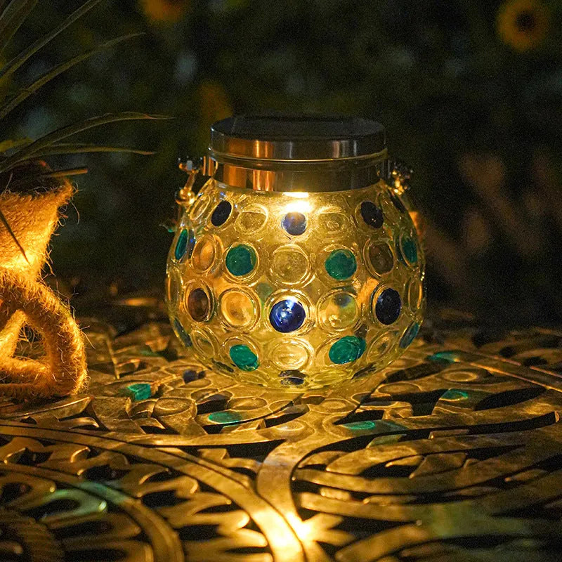 Solar decorative wave point outdoor night light IP65 waterproof in blue colour on a garden table