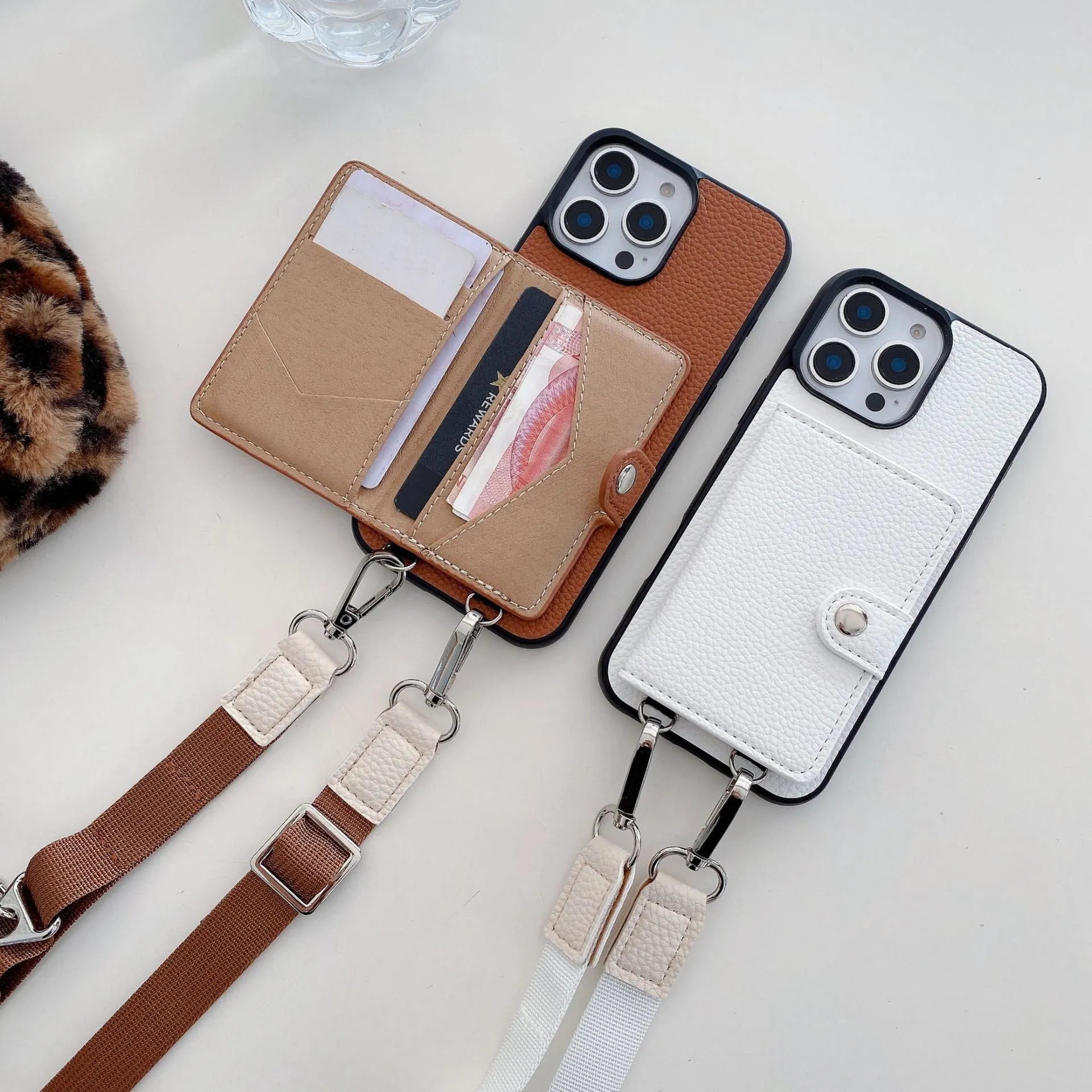 Black PC leather iPhone case with a visible card slot and a lanyard loop on the corner.