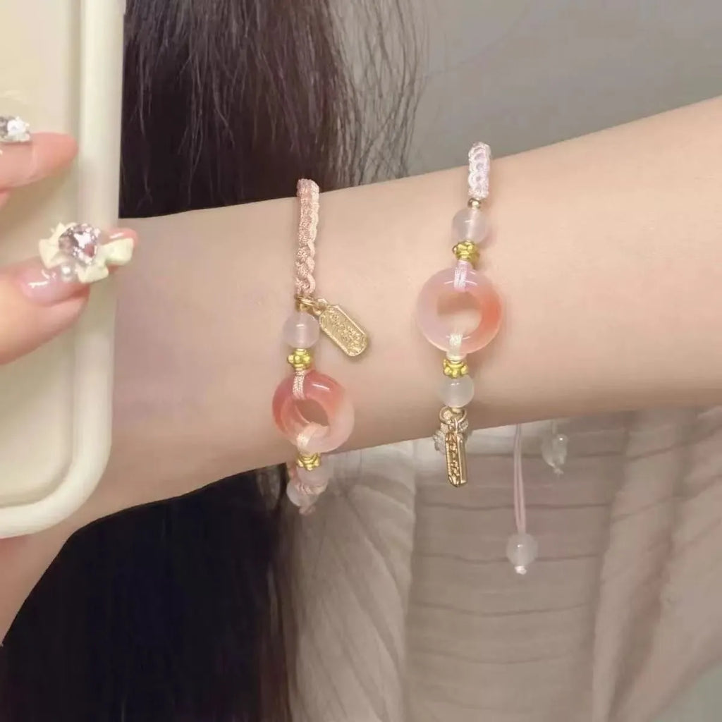 Women's woven bracelet with peach blossom minority ethnic design and peace buckle closure
