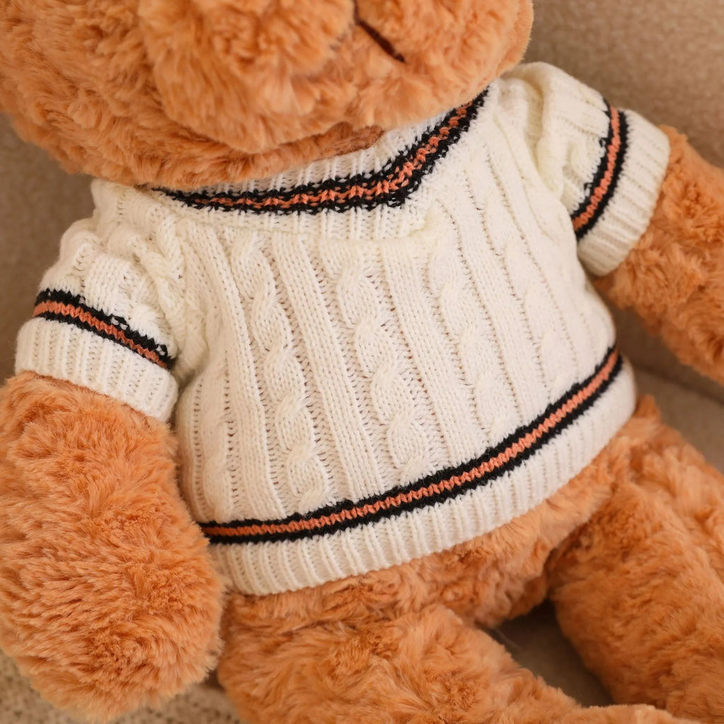 White sweater teddy bear plush doll with PP cotton filling and cloth velvet cover, shown in front view