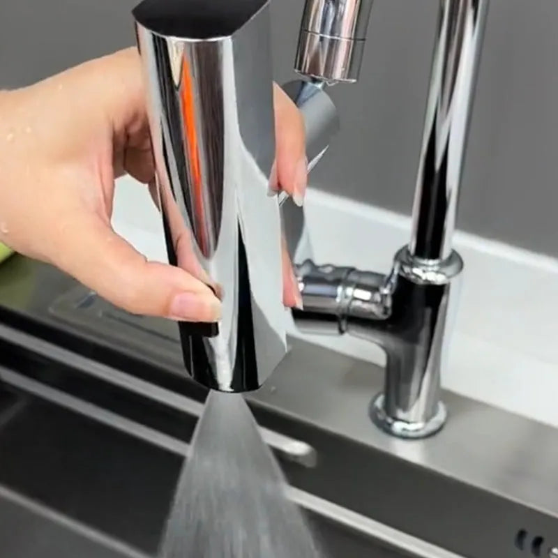 Brushed nickel kitchen faucet connector with pull-down sprayer, showing waterfall water flow mode.