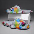 Pair of open-toe EVA slippers with a shark couple design on the footbed.