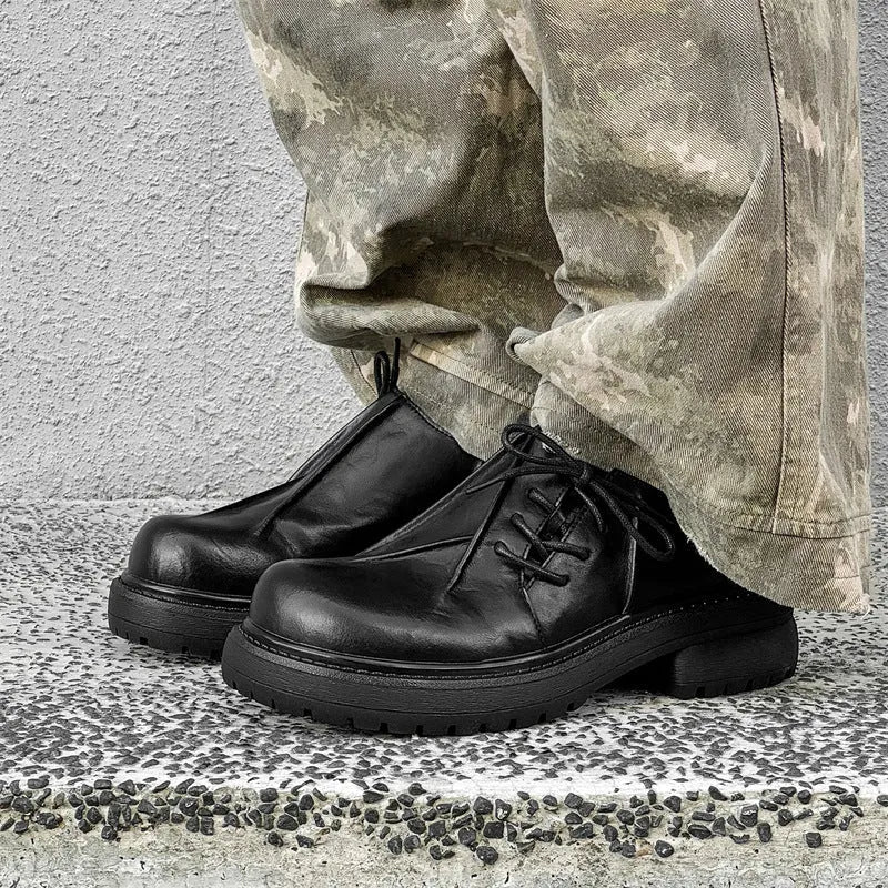 Black leather platform shoes with warped head design and rubber sole