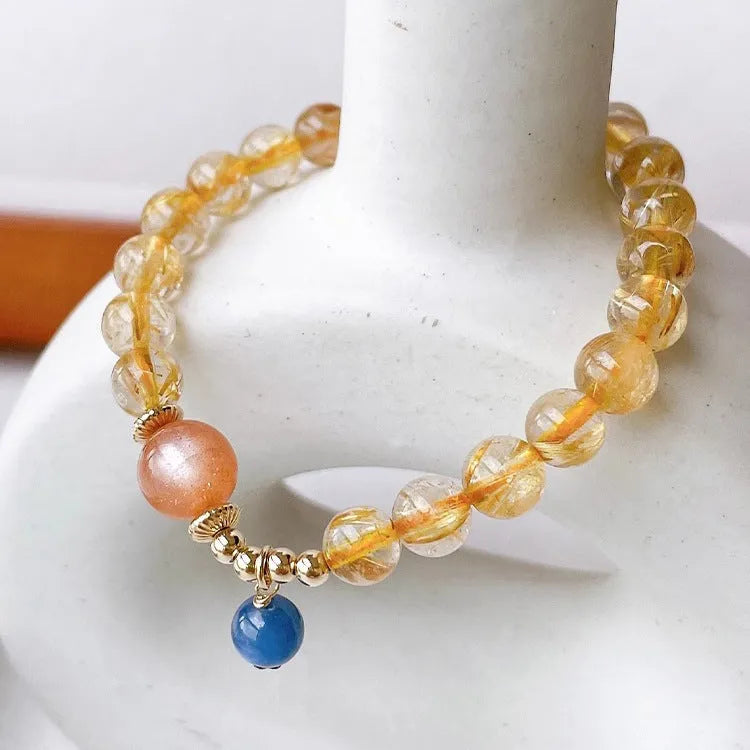Gold rutilated quartz sunstone bracelet with round beads and diamond-shaped elements