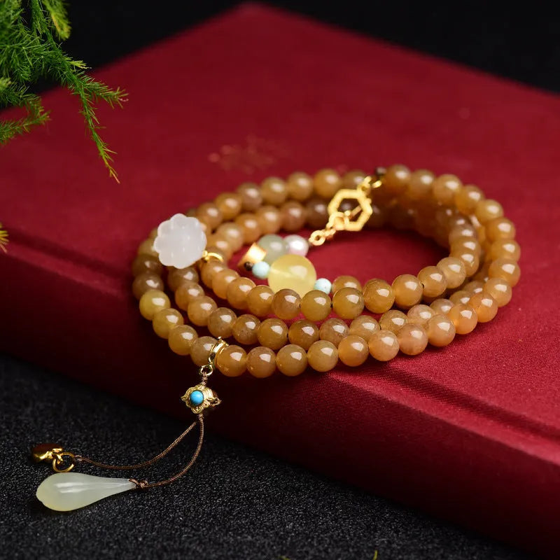 Women's natural bracelet with green pine beads, jade leaves, and beeswax accents