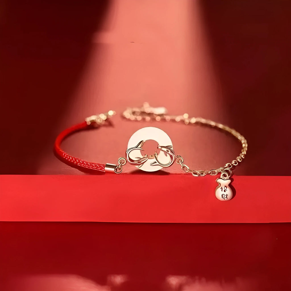 Festive koi bracelet with peace buckle fastening, adjustable red rope and fish tail decorative elements