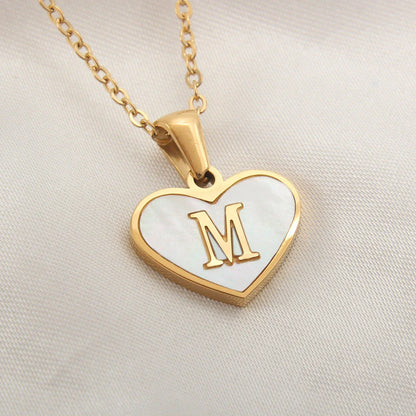 A personalized heart-shaped necklace with a 26-letter charm, crafted from high-quality stainless steel and gold plating.