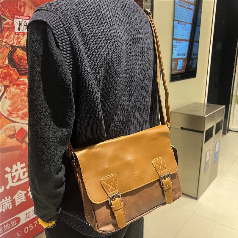 Retro men's messenger bag in light brown PU material with shoulder strap on neutral background