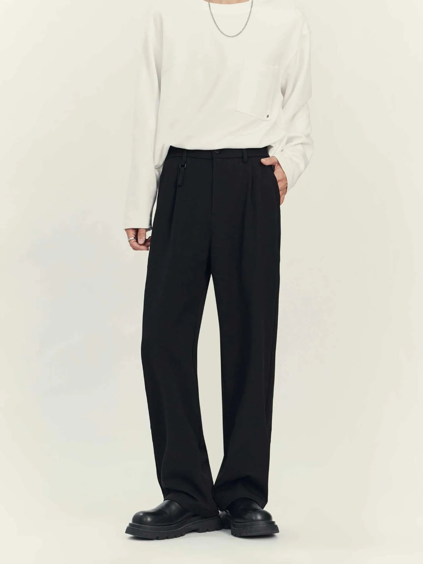 Black drape-effect loose straight-leg business casual trousers on a hanger.