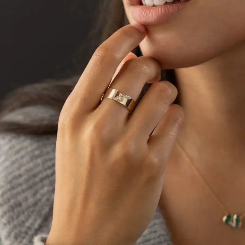Gold-colour women's ring with zircon centrepiece showing front and side views