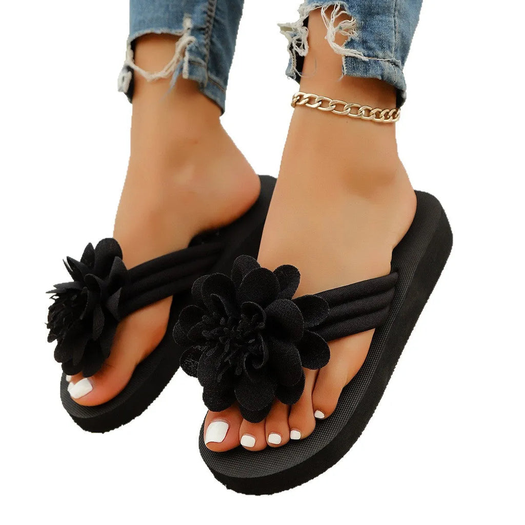 Solid colour flower flip-flops with a floral detail on a viscose upper and a lightweight EVA sole.