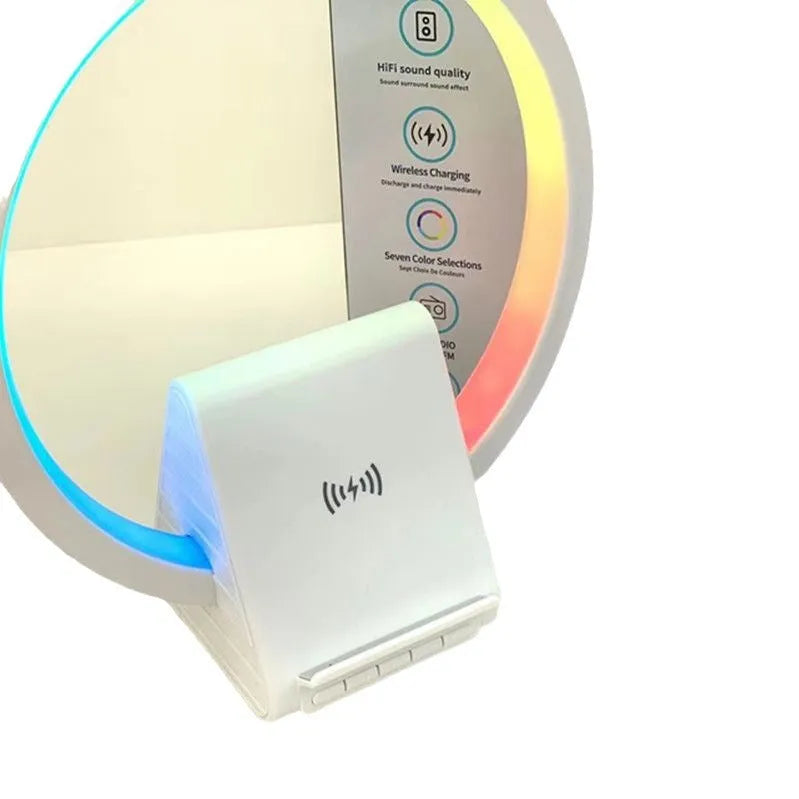 White smart Bluetooth speaker with integrated wireless charging pad and ambience light on a desk.
