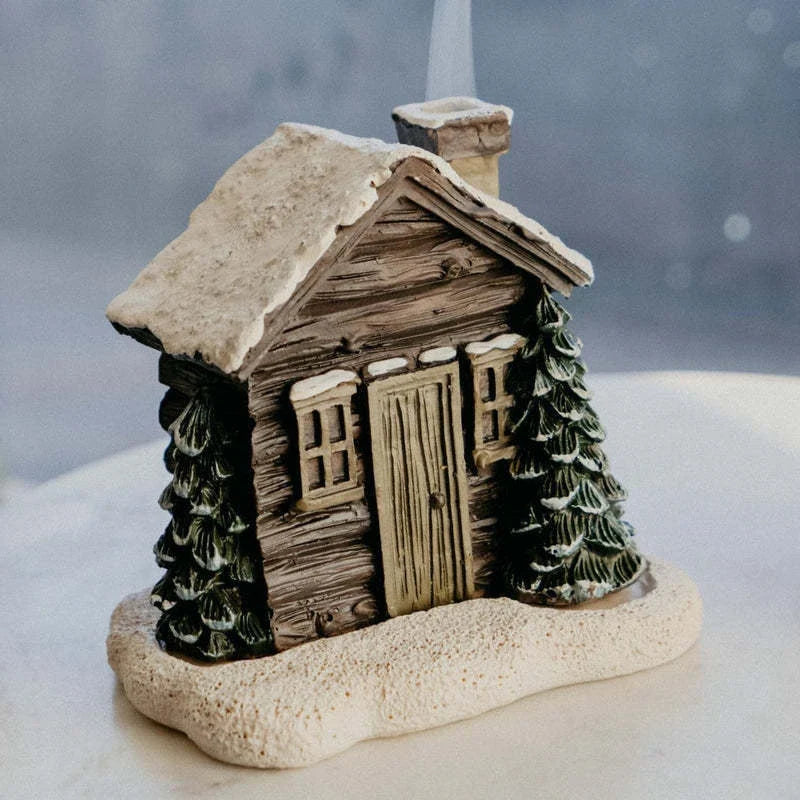 Rustic log cabin-shaped incense burner with wood-inspired finish, creating a cozy and inviting atmosphere in the home