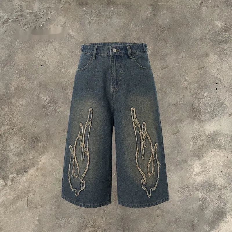 Men's cropped denim shorts with flame embroidery patch in black and blue colours, straight cut for summer street style
