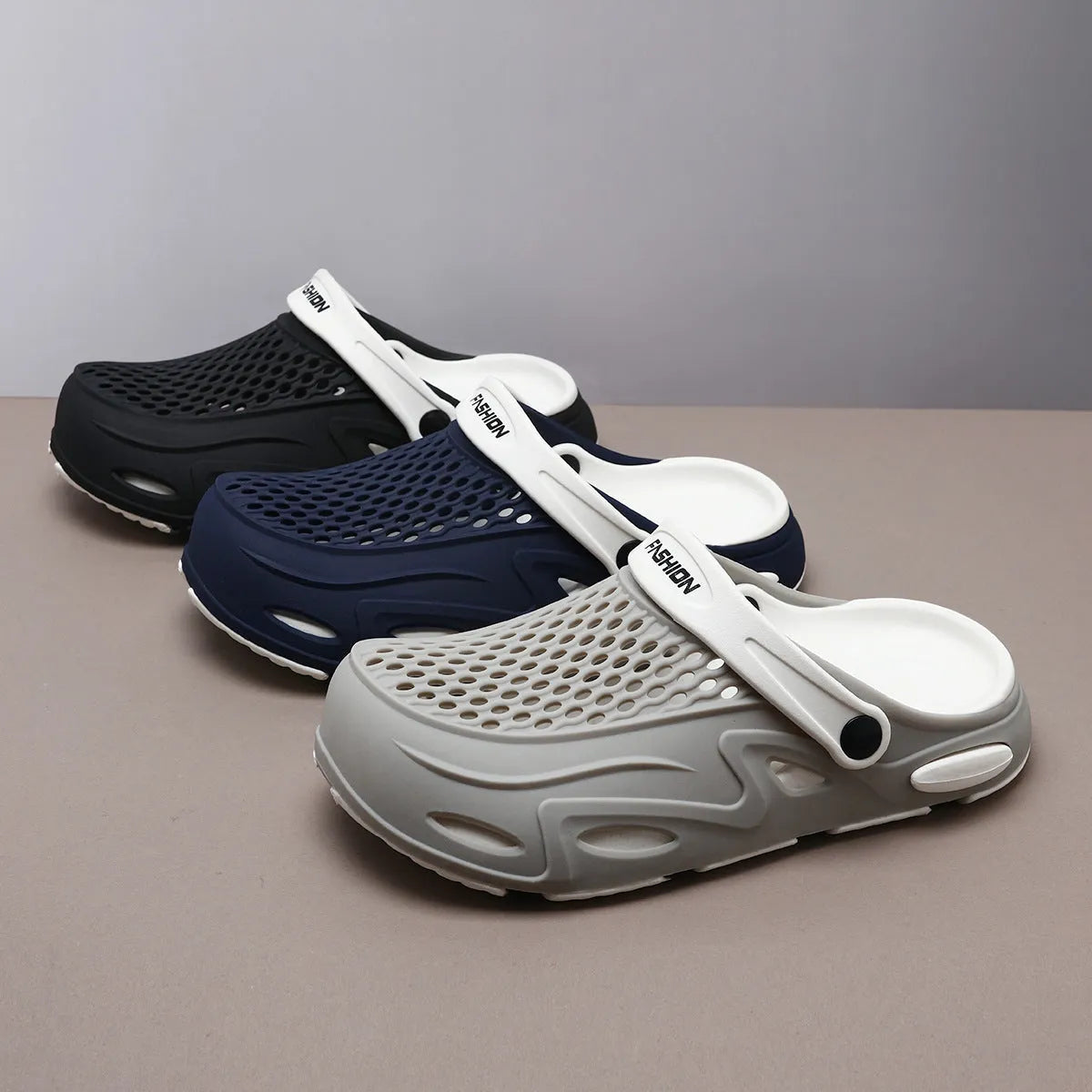 Men's grey closed toe beach slippers with a grid pattern design and a flat sole.
