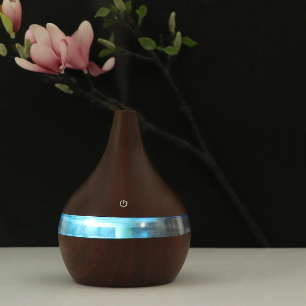 USB-powered mini humidifier in columnar design with wood grain finish and remote control