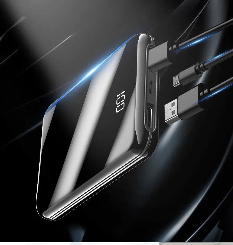 Black mini power bank with digital LCD screen showing battery percentage, next to a smartphone.