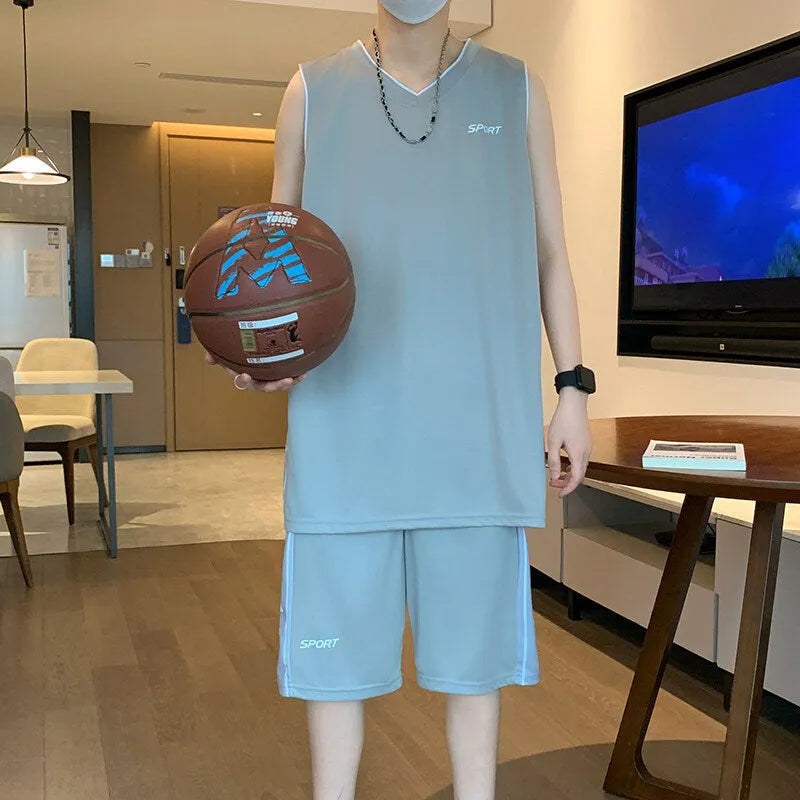 Men's grey polyester sleeveless basketball vest and matching shorts sports set laid flat