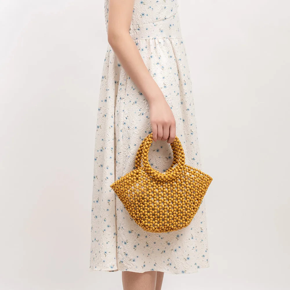 Hand-woven wooden bead beach handbag dumpling shape turmeric colour 13x7x18cm