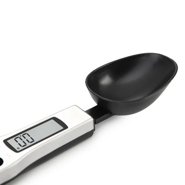 Digital kitchen measuring spoon with LCD screen showing weight measurement