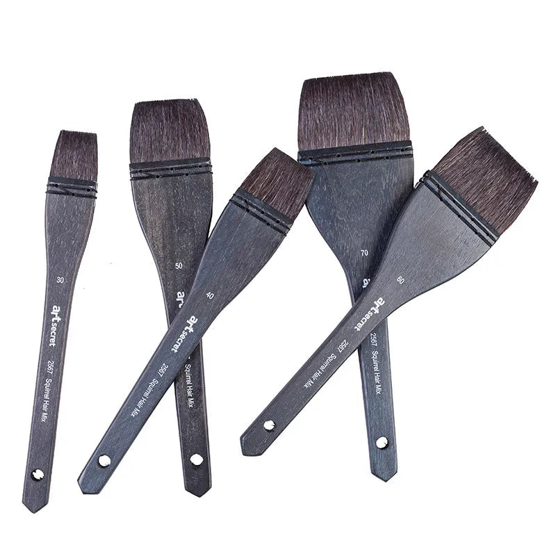 Squirrel hair makeup brush with natural wood handle on a clean surface.