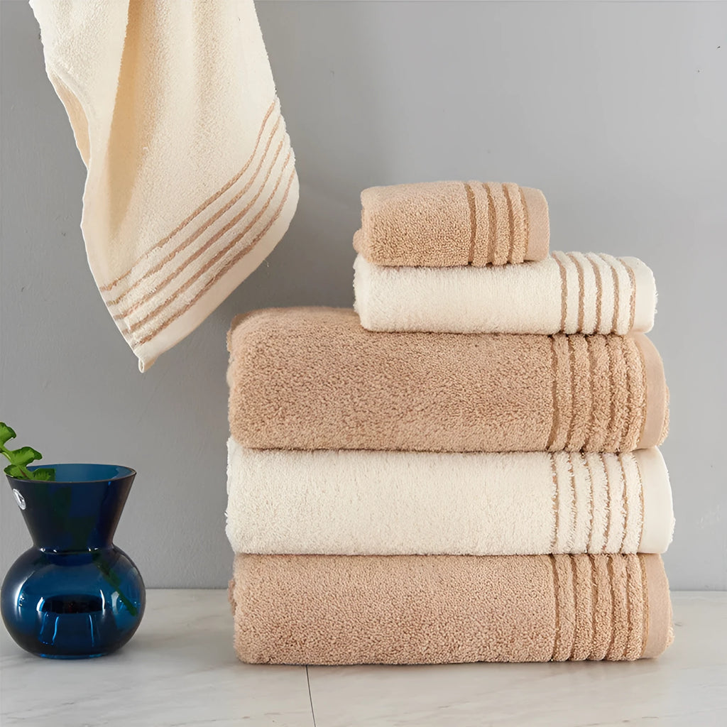Cotton towel set in beige and brown showing face, hand, and bath towel sizes