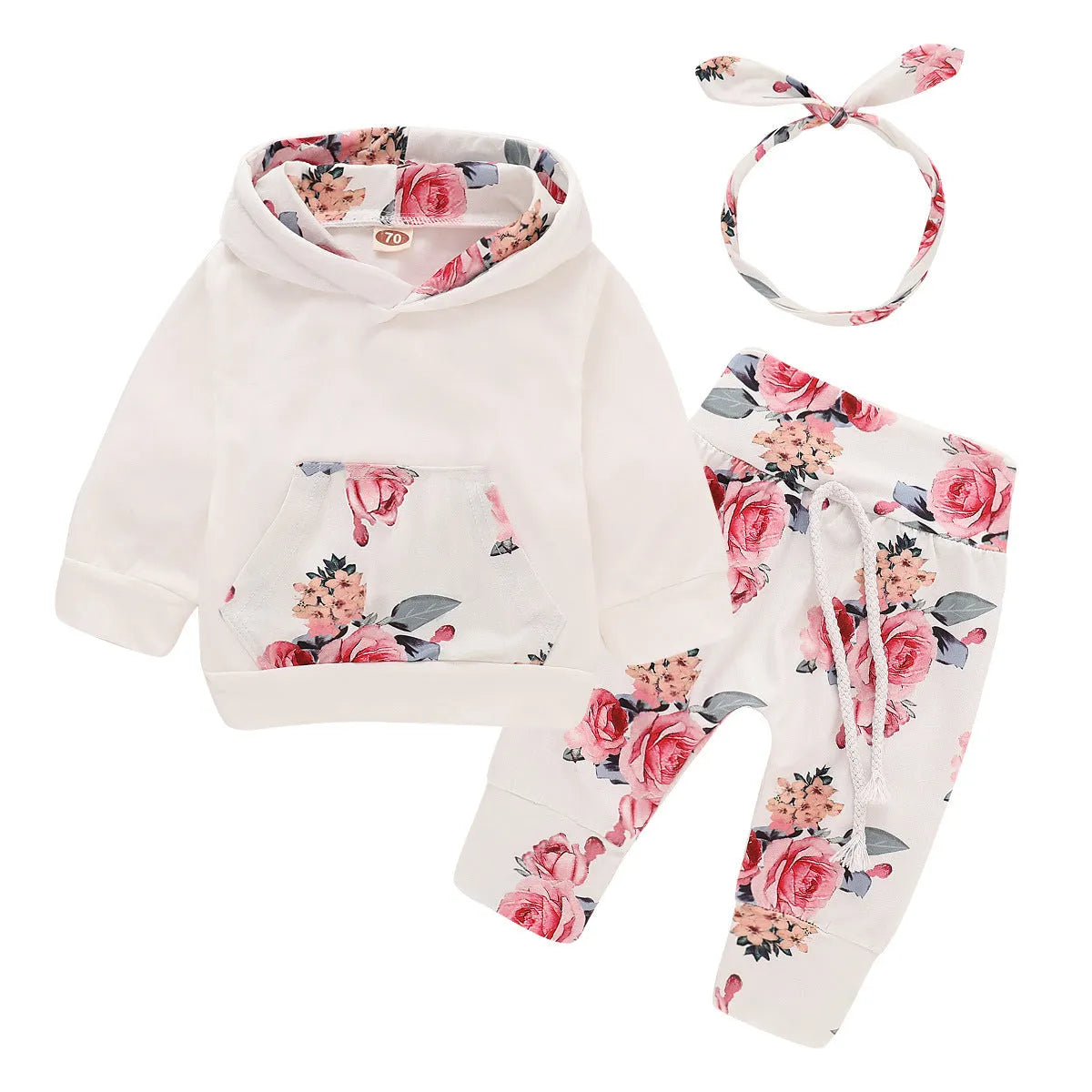 White cotton hooded tracksuit romper for a baby girl, showing long sleeves and full-length trousers.