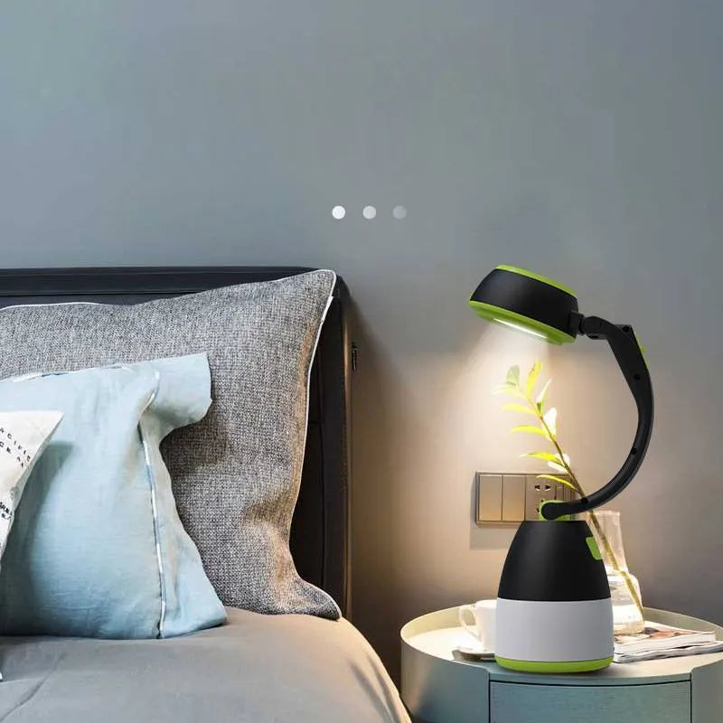 Black green multifunctional 3-in-1 foldable LED lamp with adjustable head on a table.
