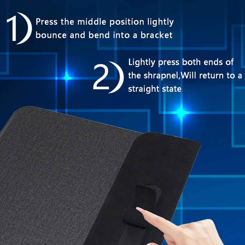 Black 2-in-1 wireless charging mouse pad on a desk with a phone resting on the built-in bracket